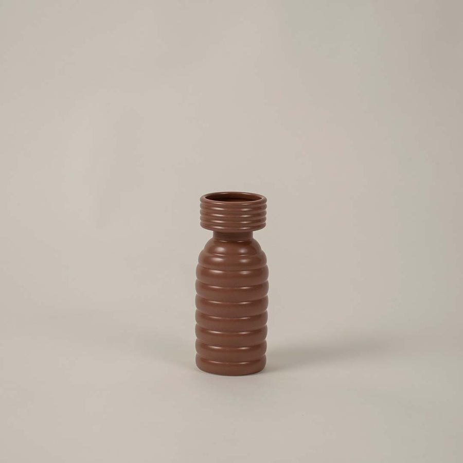 Minimal white background view of brown ribbed ceramic vase featuring smooth ribbed texture for modern styling.