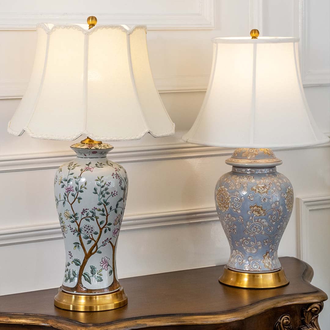 Table lamps with elegant floral bases and white shades placed on a wooden table adding charm and warmth to classic home decor.