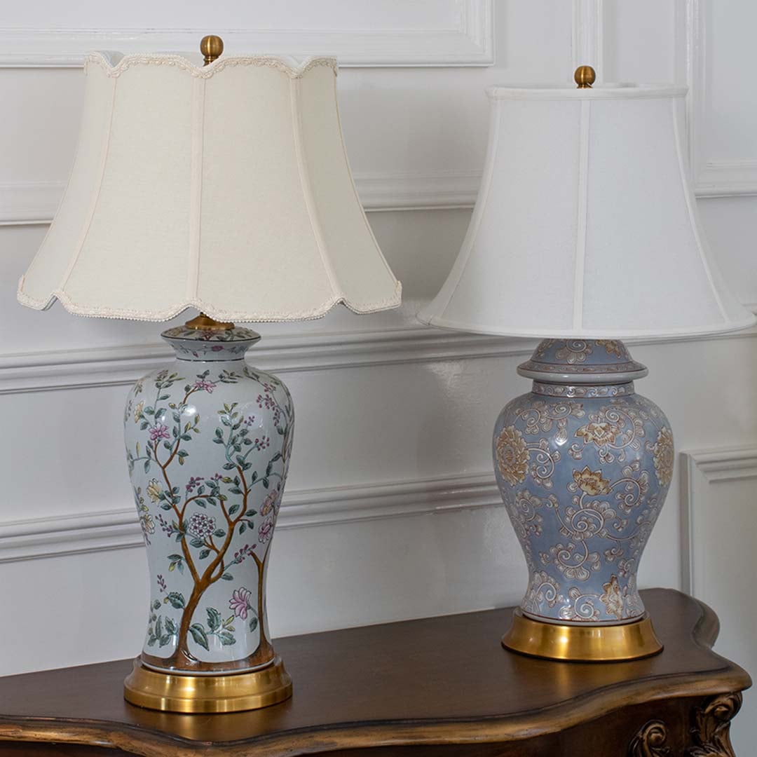 Ceramic table lamps light off showing elegant floral bases and white fabric shades placed on a wooden table for classic decor styling.