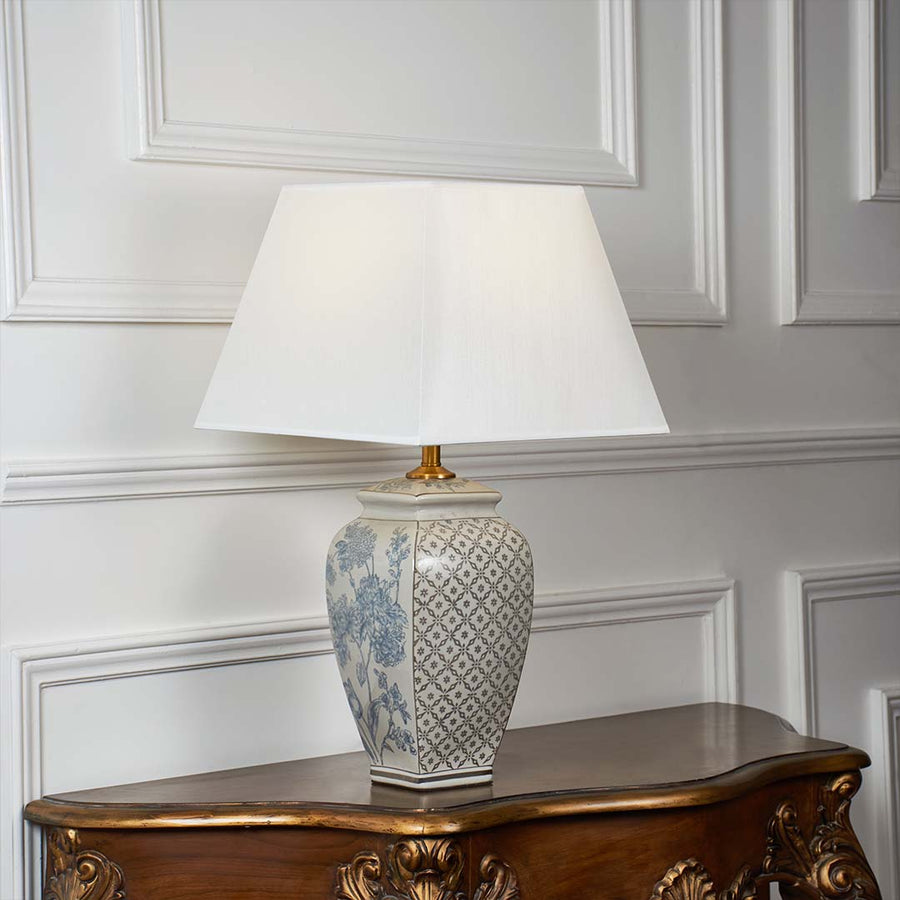 Grey patterned ceramic table lamp with fabric shade designed for elegant traditional decor and ambient table lighting indoors.