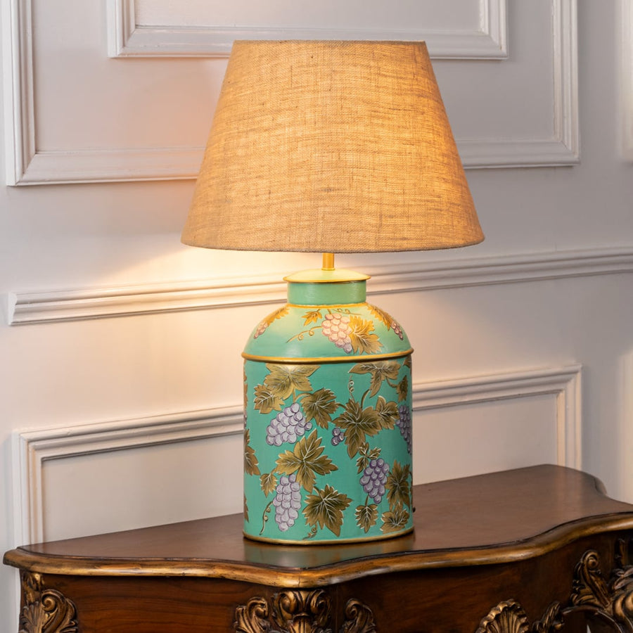 Grape Vine blue table lamp illuminated on white background highlighting flowing design gentle glow and elegant interior decor style.