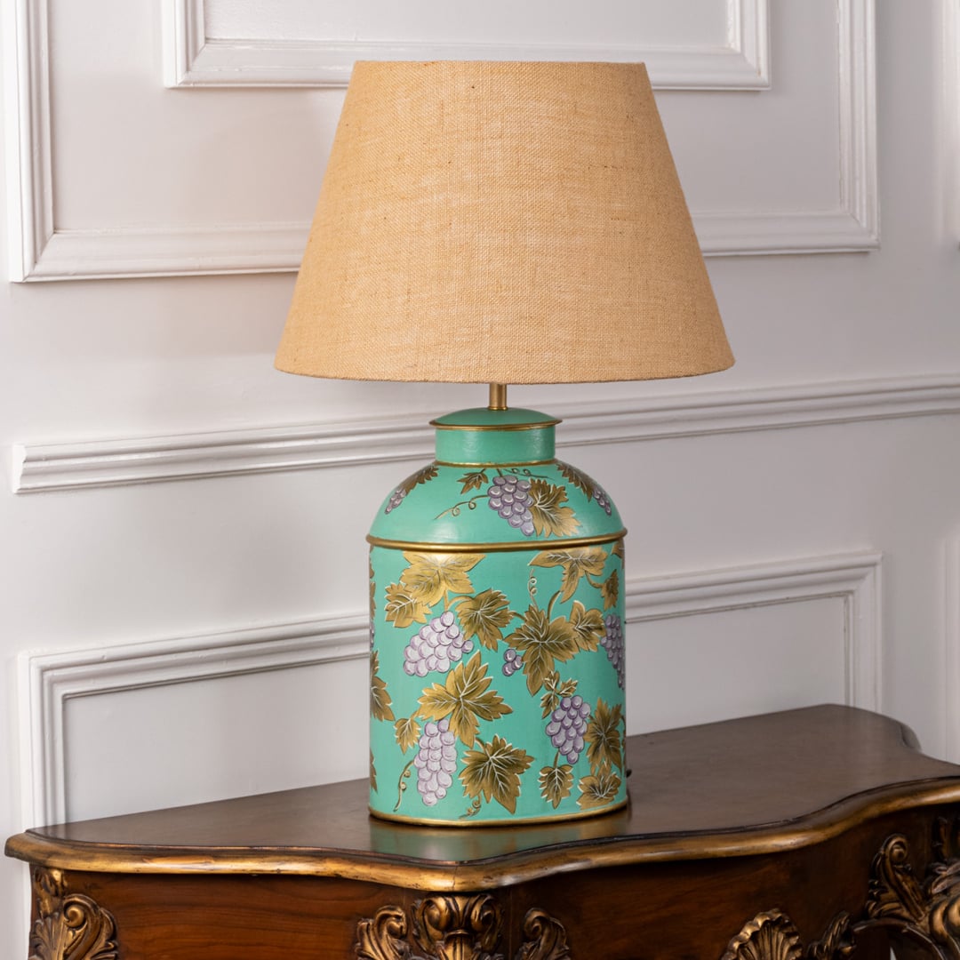 Palais mint green ceramic lamp with beige linen shade turned off on white background showing golden grapevine detailing perfectly.