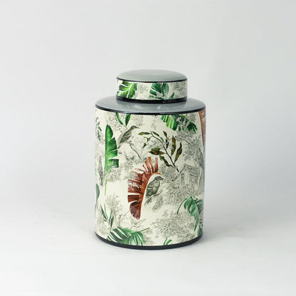 Tropical bird jar displayed on a white background showcasing detailed bird and leaf artwork.