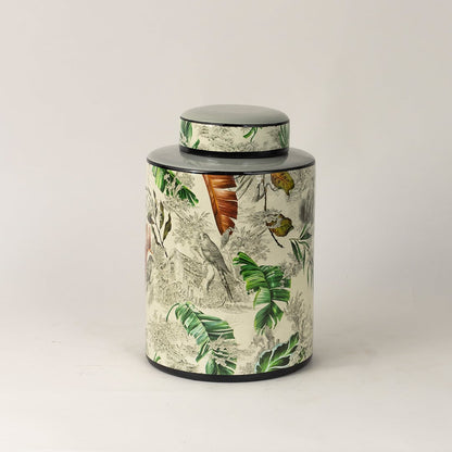 Tropical bird jar captured from side angle showing curved body and detailed bird and leaf artwork.