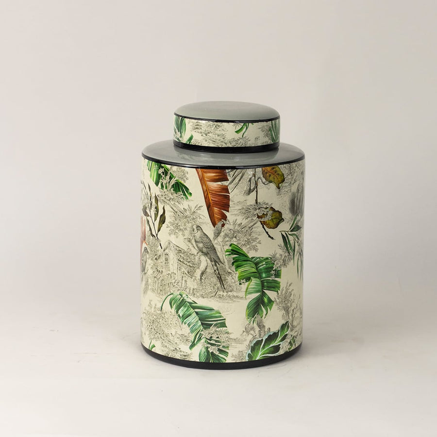 Tropical bird jar captured from side angle showing curved body and detailed bird and leaf artwork.