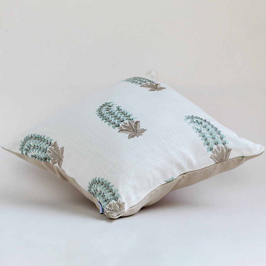 Soft cotton cushion cover with blue and green botanical motifs shown at an angle offering a natural décor accent with a breathable gentle and skin friendly fabric suitable for cozy interiors.