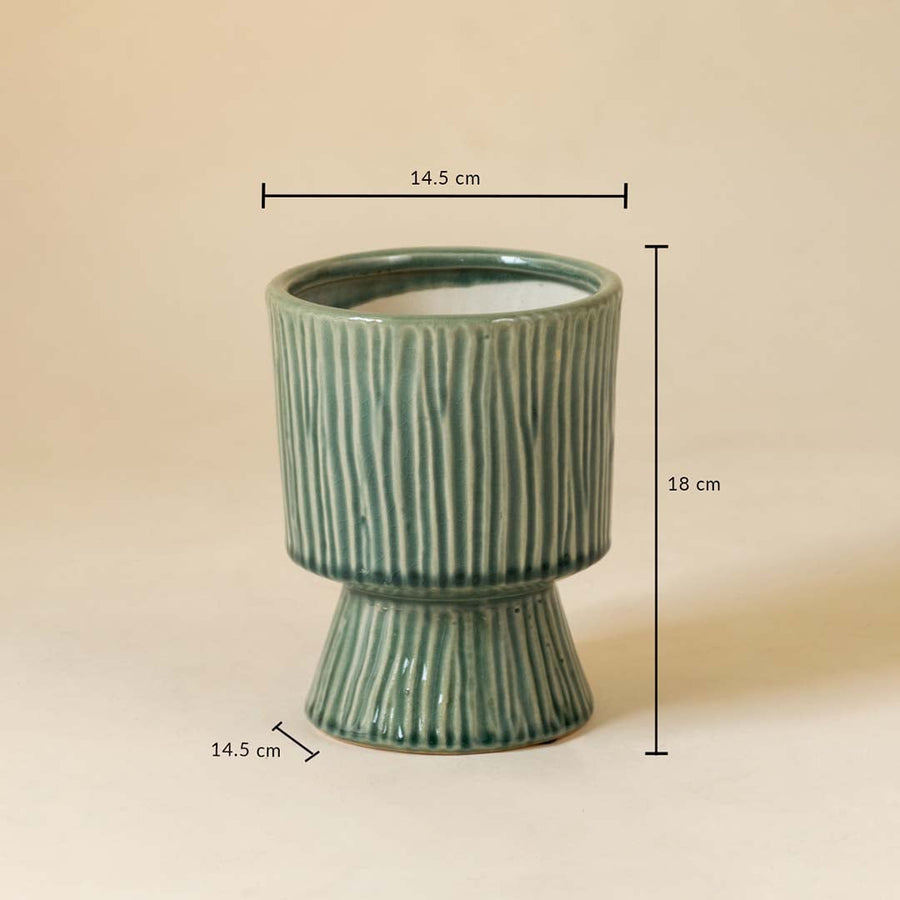 Green ribbed ceramic vase shown with 18 cm height and 14.5 cm width measurement for stylish interior decoration.