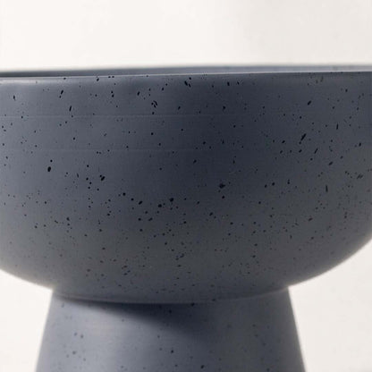 Detailed closeup of grey speckled bowl with side handles and pedestal base showing modern texture and finish.