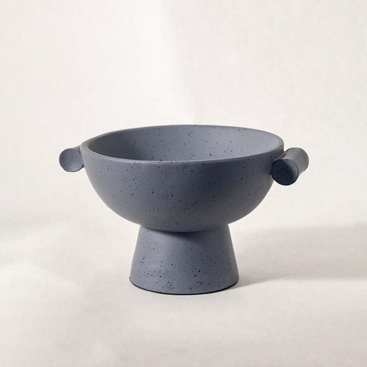 Modern grey speckled bowl with pedestal base and side handles displayed on white background for elegant styling.