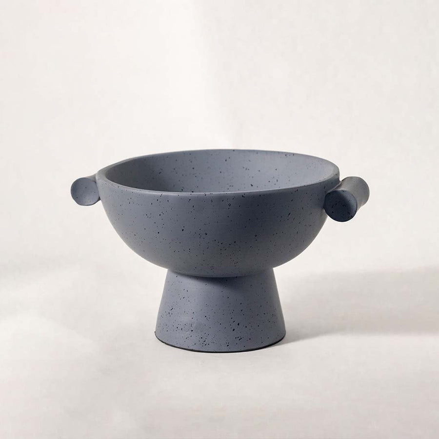 Modern grey speckled bowl with pedestal base and side handles displayed on white background for elegant styling.