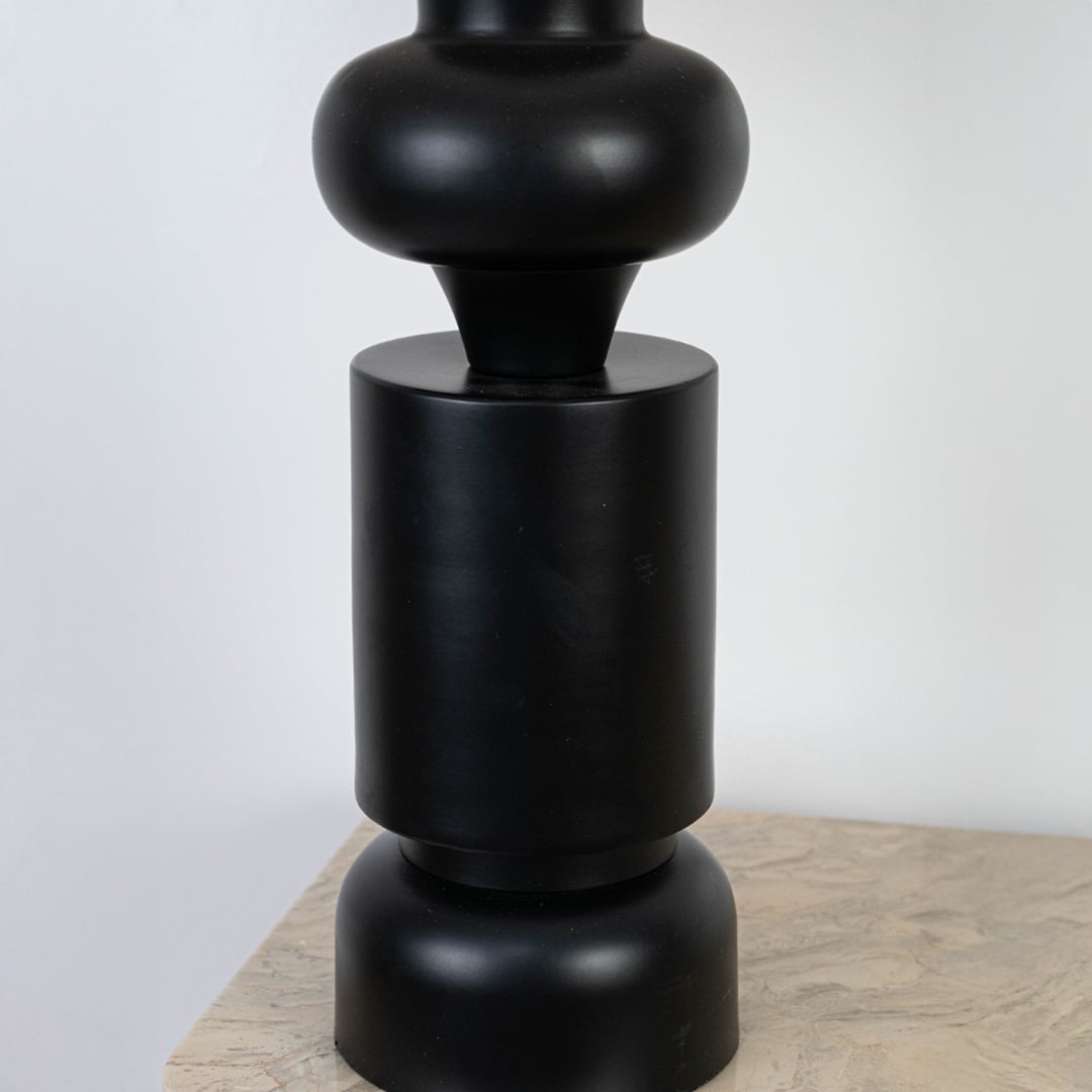 Close-up of the green ceramic lamp base showcasing its smooth matte finish and cylindrical shape.