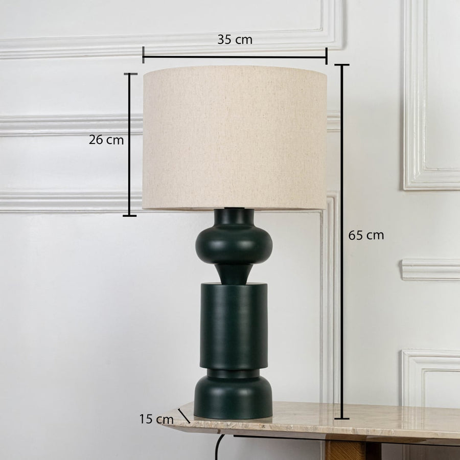 Dark green ceramic table lamp with cream shade shown with measurements of height 65 cm and shade width 35 cm.