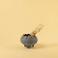 Grey metal scalloped bowl planter decor styled in a warm modern space adding a subtle elegant accent to living room tables.