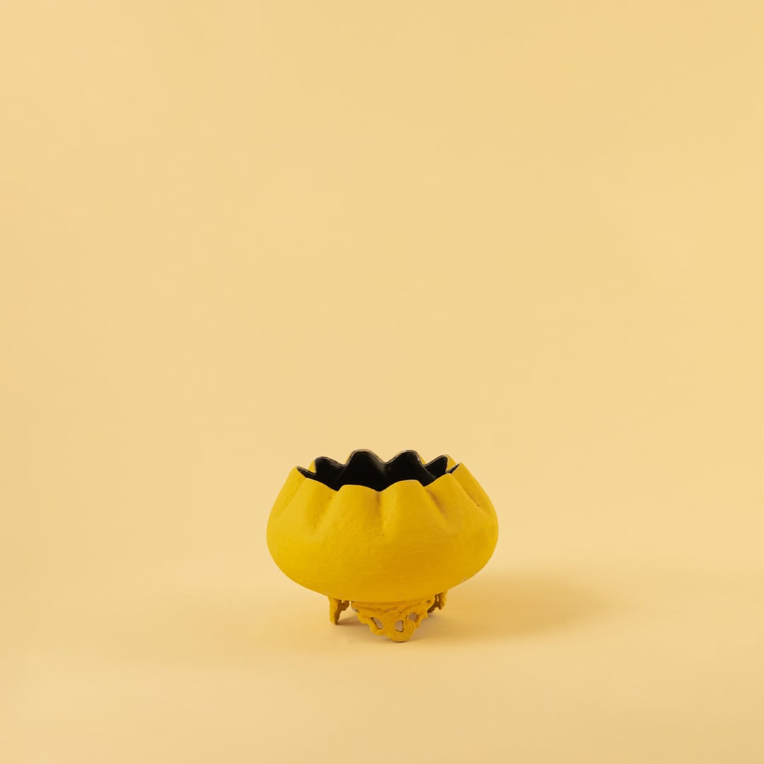 Yellow metal scalloped bowl planter decor on a clean white background highlighting its bold textured finish for home styling.