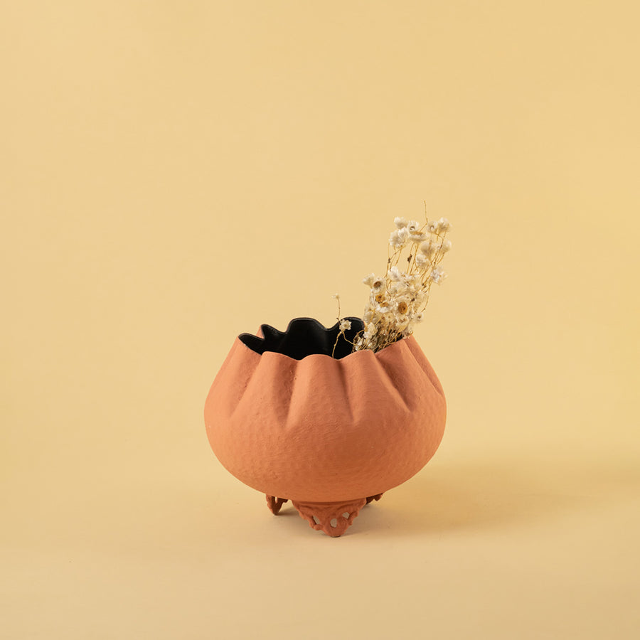 Small textured terracotta bowl planter with dried stems for warm modern home decor and minimalist table style.
