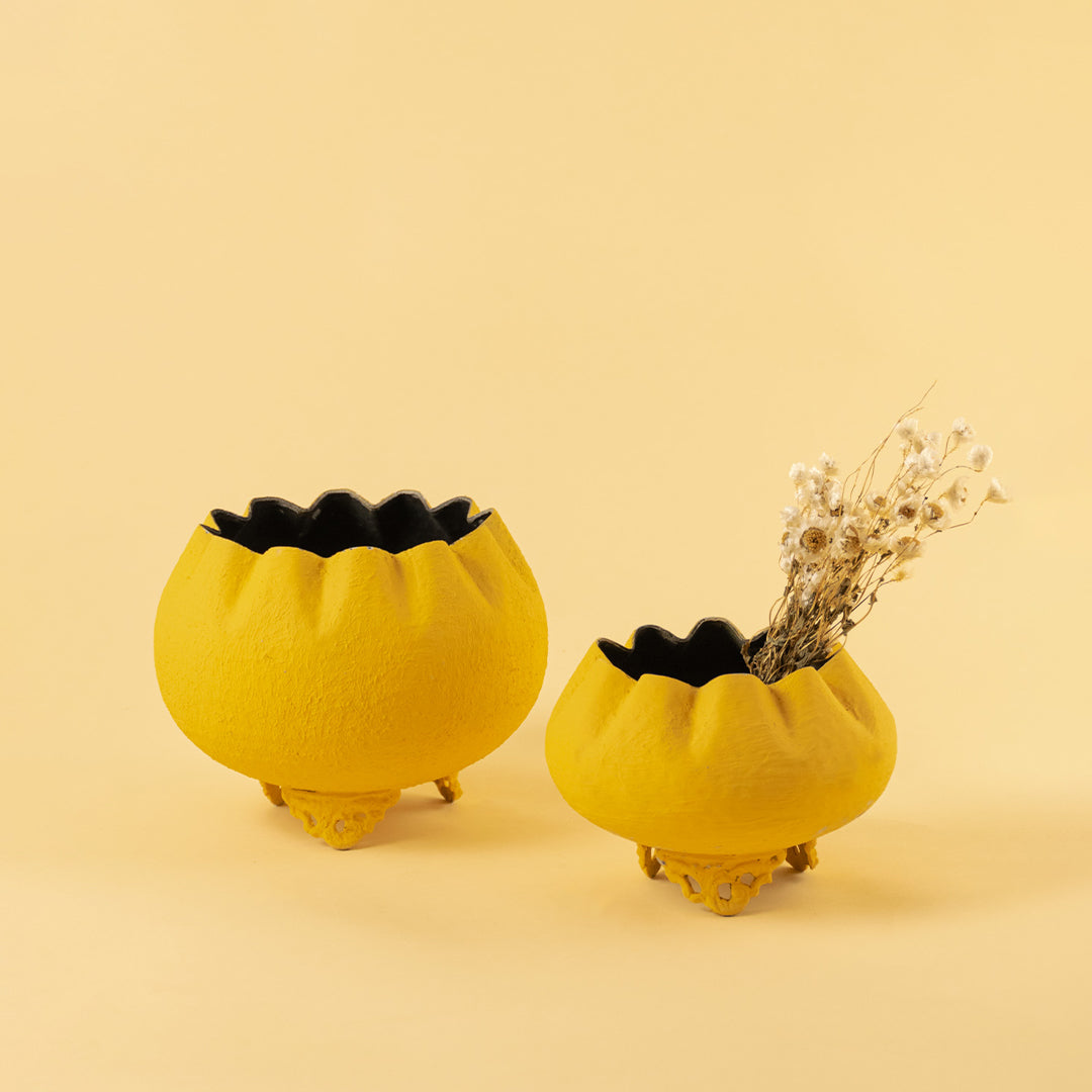 Pair of vibrant textured yellow bowl planters for creative modern home decor and artistic tabletop centerpiece design.