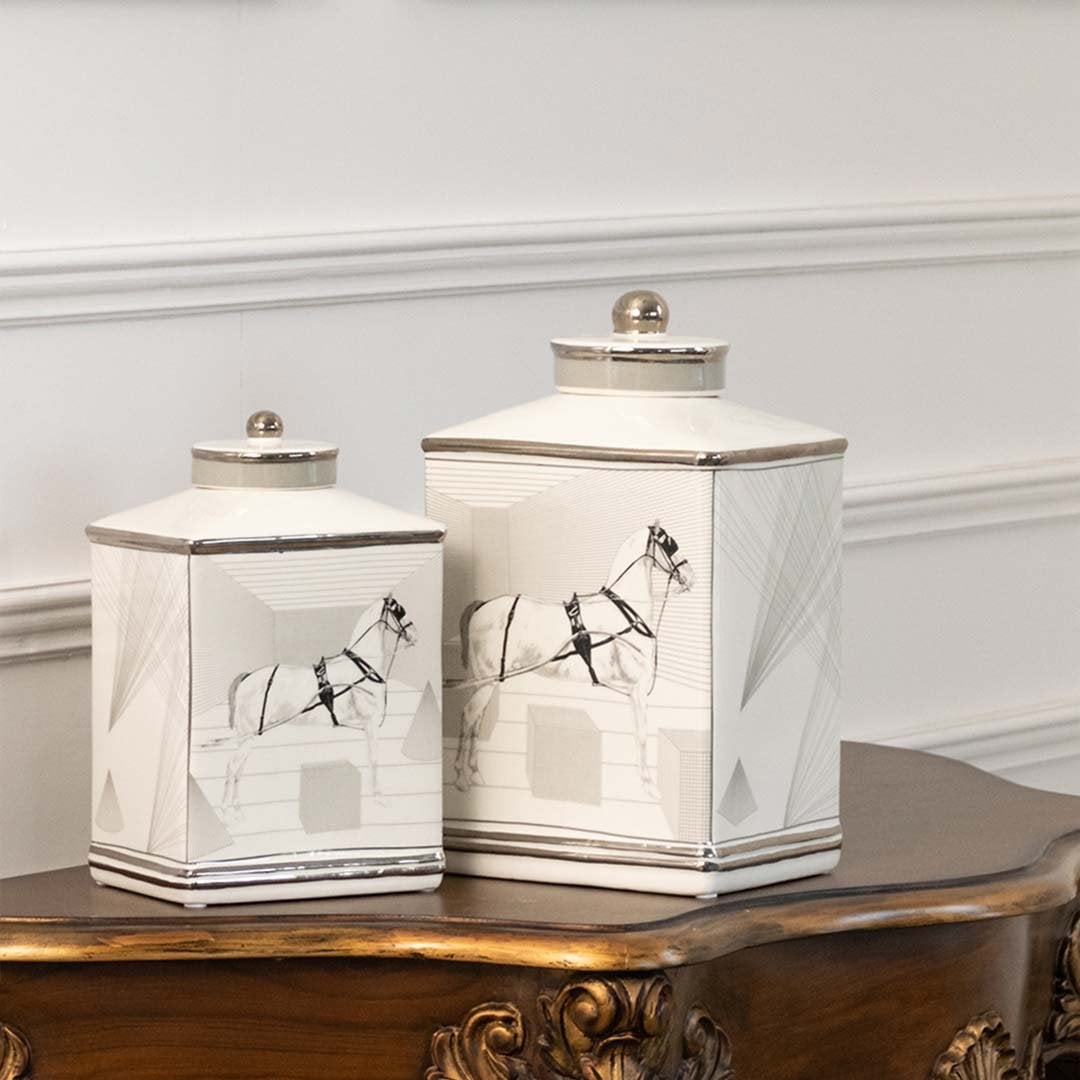 White ceramic jars with crane artwork displayed on console for elegant minimalist décor styling.