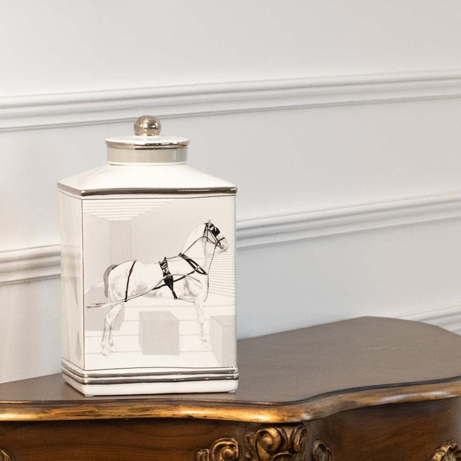 White ceramic jar with crane artwork displayed on a console for elegant luxury home décor accents.