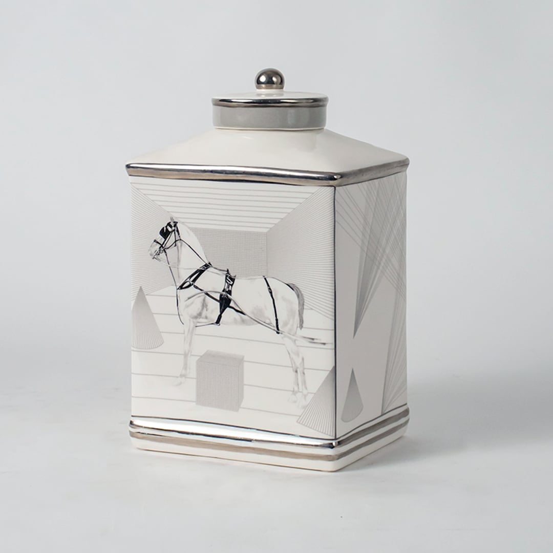 White ceramic jar with crane artwork shown on simple background for elegant luxury home décor styling.
