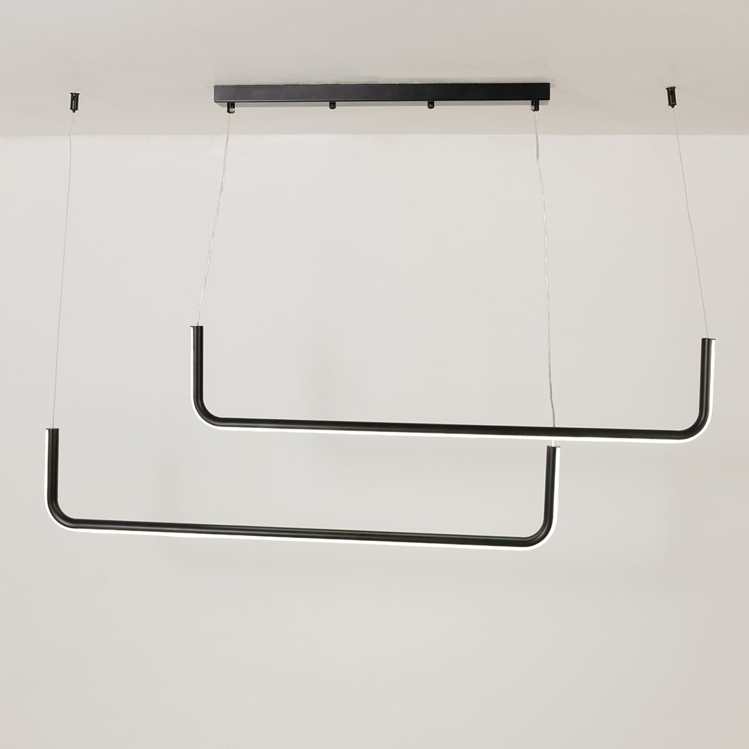 Modern black hanging light glowing softly on a bright white background showing a sleek dual bar design for stylish interiors.