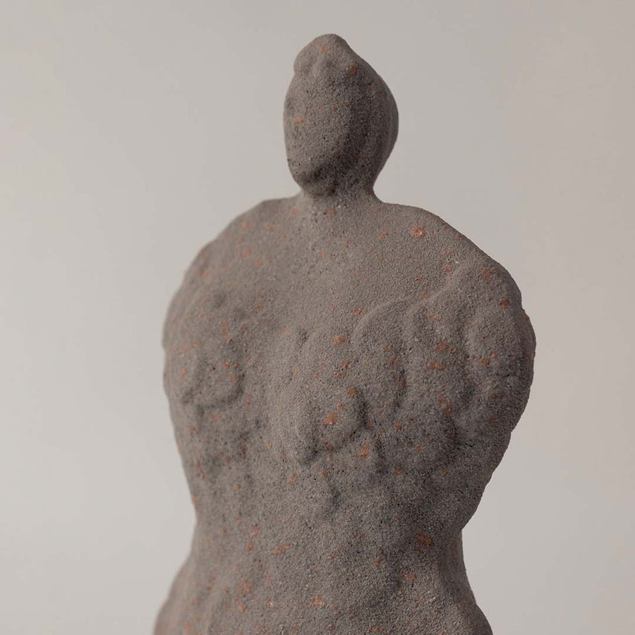 Textured grey ceramic sculpture closeup highlighting rough handmade surface and abstract form for artistic interior accent display.