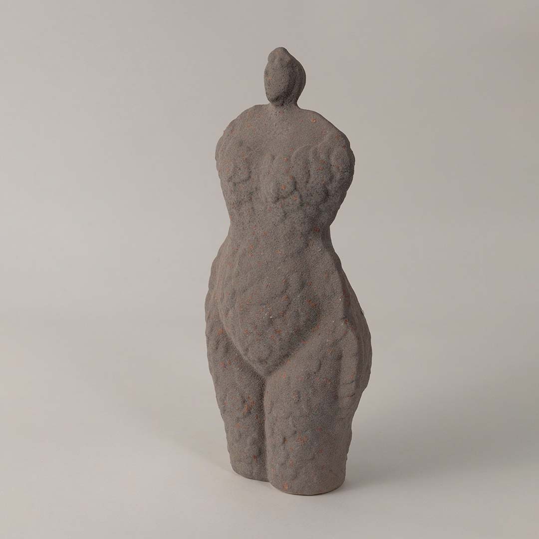 Side angle view of grey ceramic torso sculpture vase with unique handcrafted texture styled for modern home and office decor.