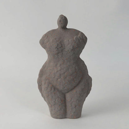 Abstract ceramic torso sculpture with textured grey finish placed on white surface against neutral background showcasing artistic modern home decor accent.