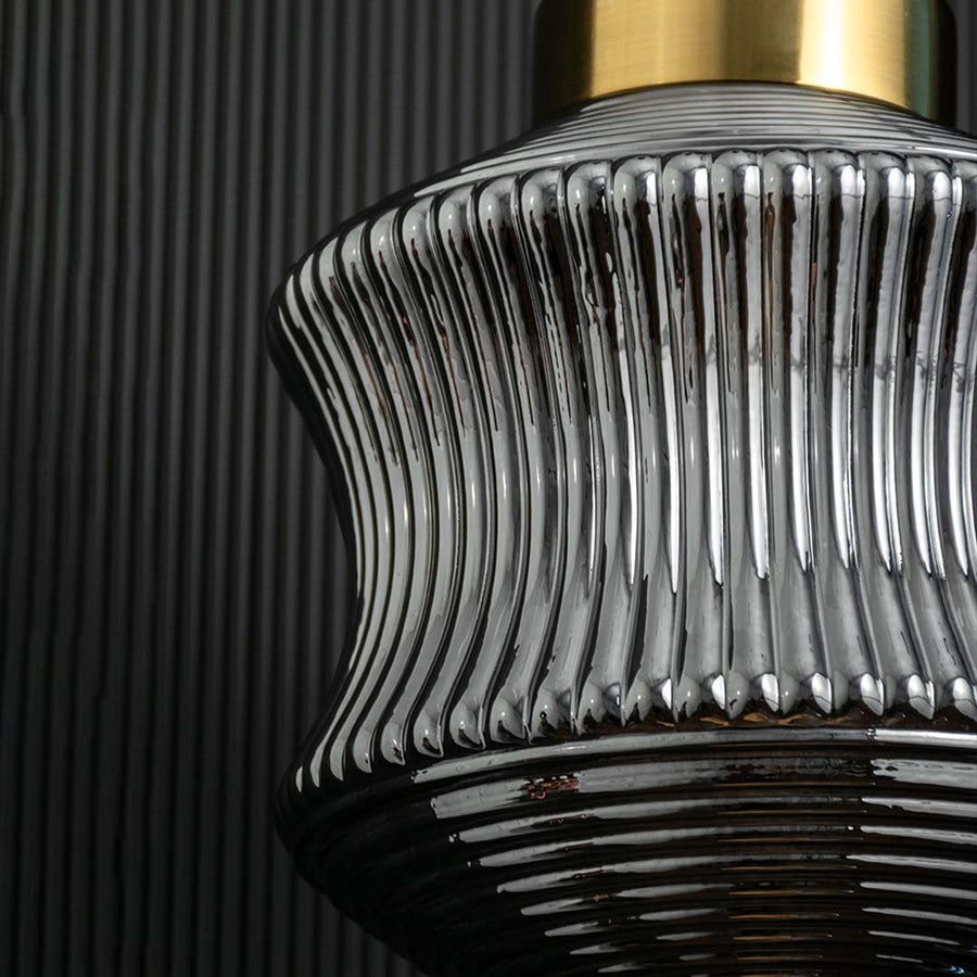 Closeup of ribbed smoked glass pendant light capturing its gold top textured glass pattern and elegant handcrafted detailing.