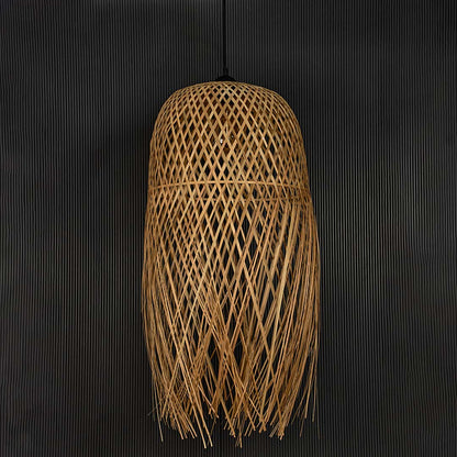 Fringe rattan pendant light with handwoven bamboo shade in natural finish turned off against black background.