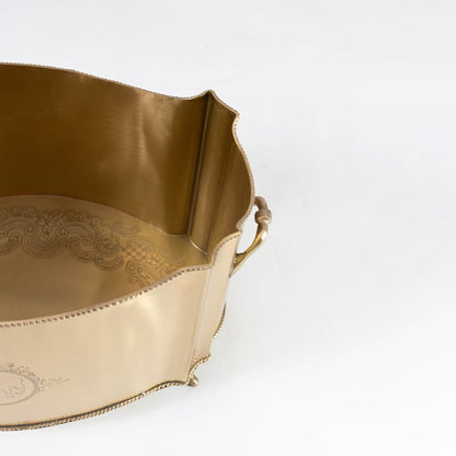 Gold metal oval planter with engraved crest and handles displayed on white background with measurements 30 cm by 20 cm.