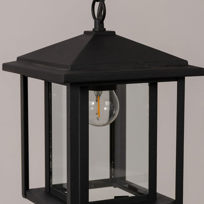 Closeup outdoor lantern in black metal with glass panels for entrance or garden decor lighting white background.
