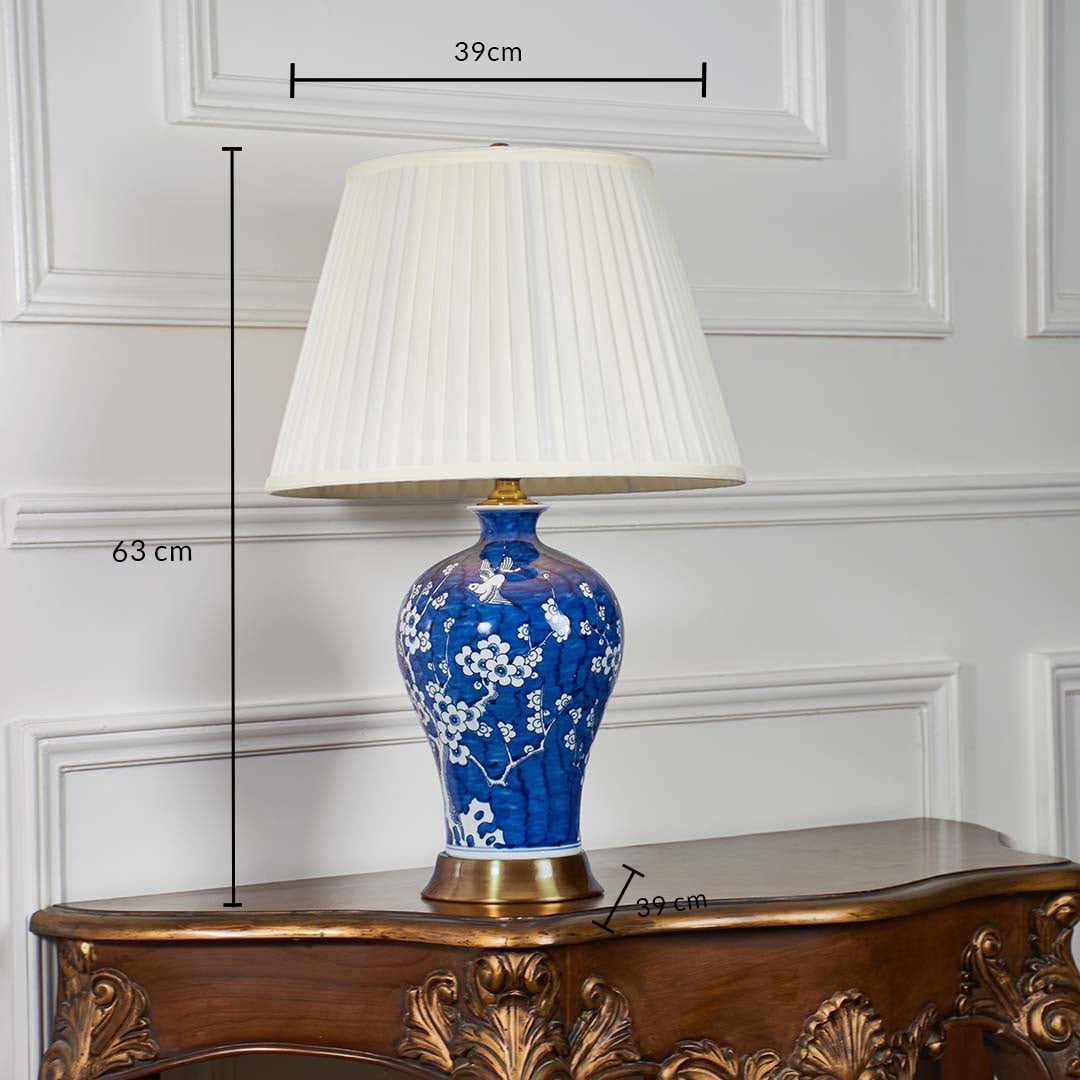 Blue ceramic floral table lamp shown with 63 cm height 39 cm shade width and 39 cm base width on a wooden console for accurate size reference.