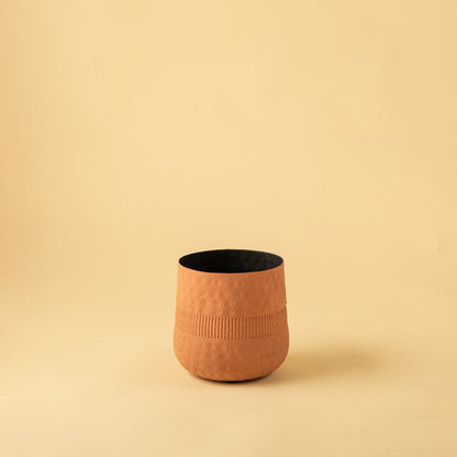 Small terracotta textured pot with black interior displayed on a clean white background for minimal modern home decor.