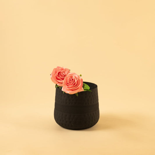 Small black textured pot with matte finish styled in a modern home setting adding bold minimal decor to shelves and tables.