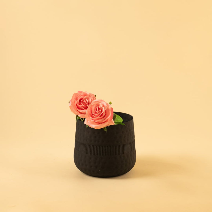 Small black textured pot with matte finish styled in a modern home setting adding bold minimal decor to shelves and tables.