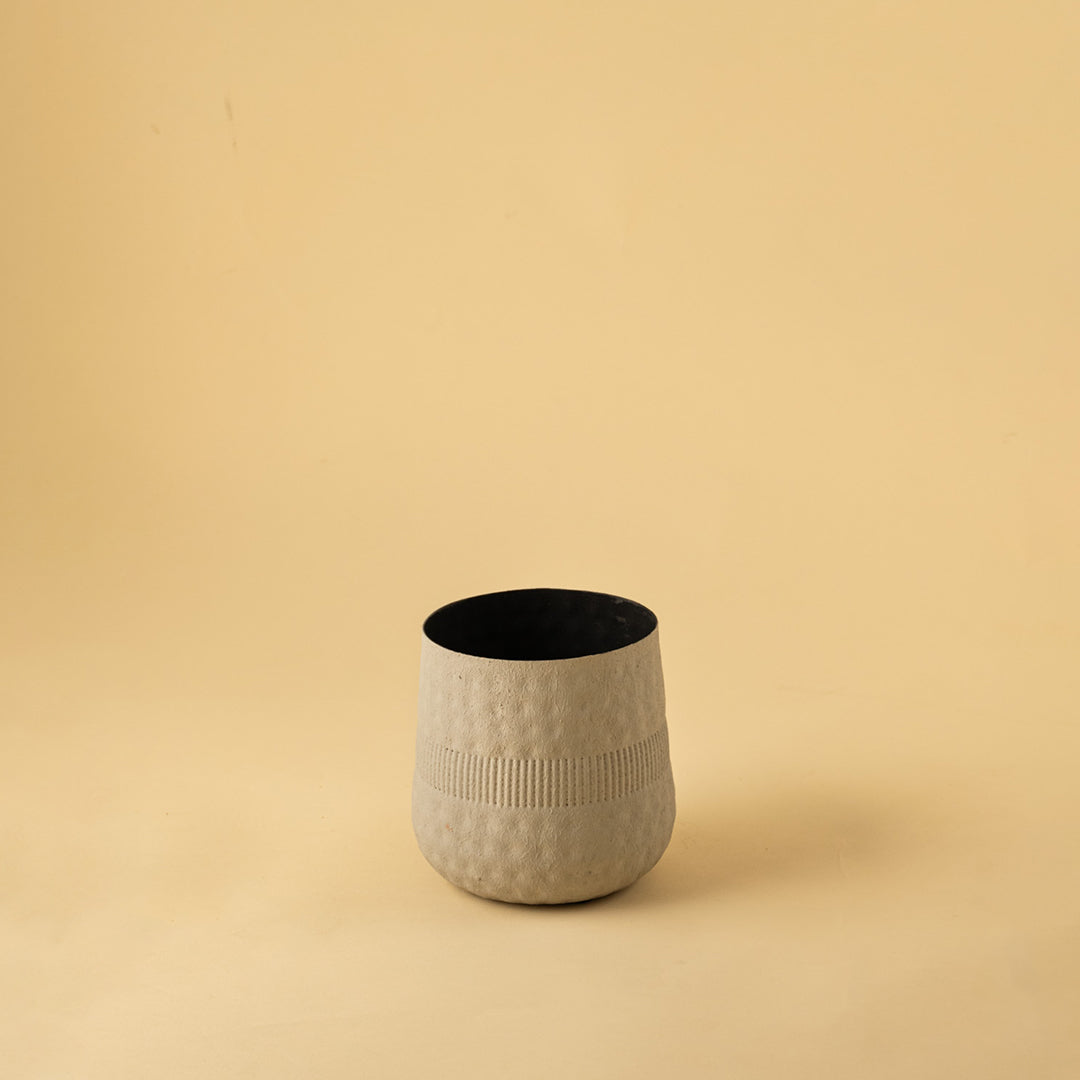 Simple textured beige metal vase for clean minimalist home decor and contemporary shelf display accent needs.