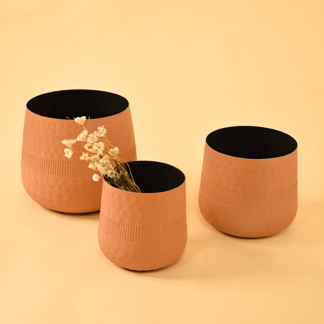 Terracotta textured pot displayed with coordinating decor pieces forming a cohesive modern styling arrangement.