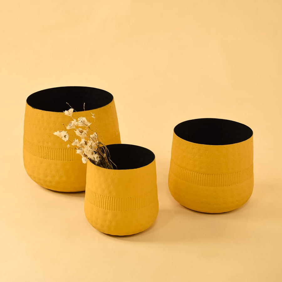 Small yellow textured pot displayed with matching decor pieces creating a coordinated modern decorative styling look.