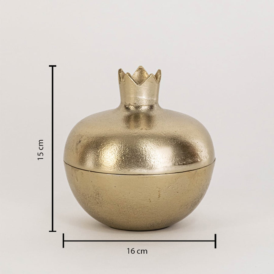 Close view of gold pomegranate storage jar highlighting smooth metallic finish and sculpted crown lid detail.