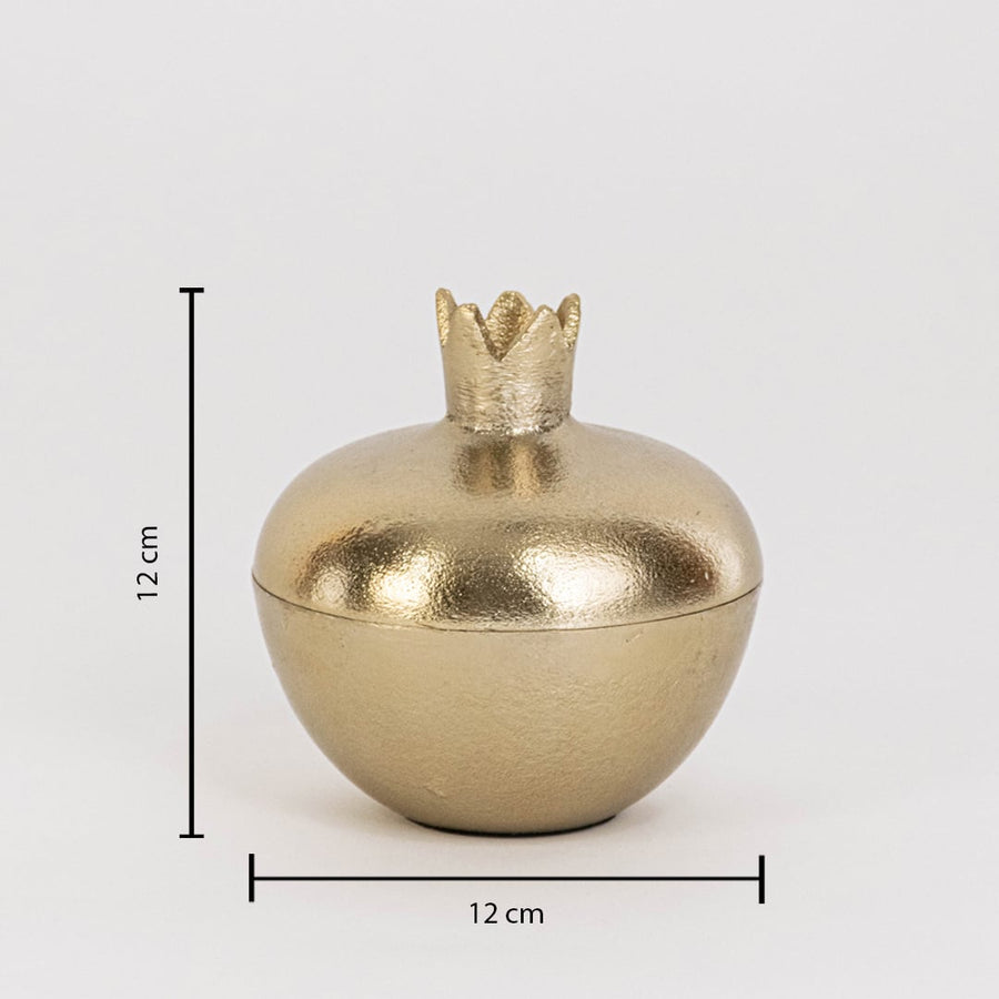 Gold metal pomegranate jar measuring 12 cm tall and 12 cm wide with crown lid and glossy finish shown on white wall