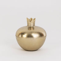 Smooth gold pomegranate-shaped jar with crown top shown on clean white background for clear product presentation