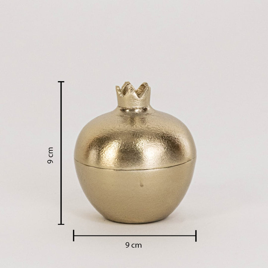 Small gold metal pomegranate jar measuring 9 cm tall and 9 cm wide shown with crown top on white background wall