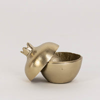Decorative metal storage bowl in gold finish with crown lid for table decor or storage styling modern home placement white background.