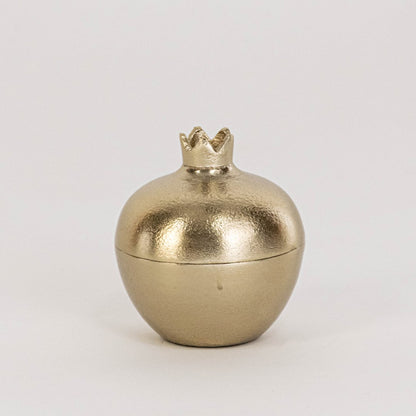 Mini gold pomegranate jar shown in room setup without white background adding subtle accent to home decor styling