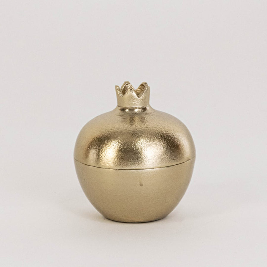 Mini gold pomegranate jar shown in room setup without white background adding subtle accent to home decor styling