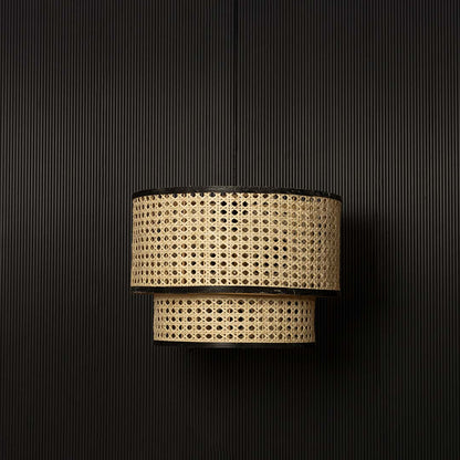Bohemian rattan pendant light with black rim and natural weave displayed off against dark background decor.