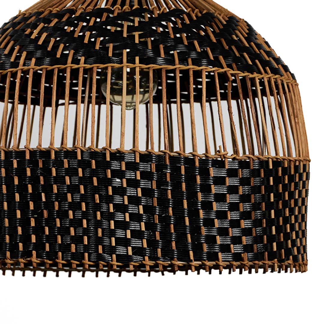 Closeup of rattan pendant light showing detailed craftsmanship with black and brown interwoven pattern.