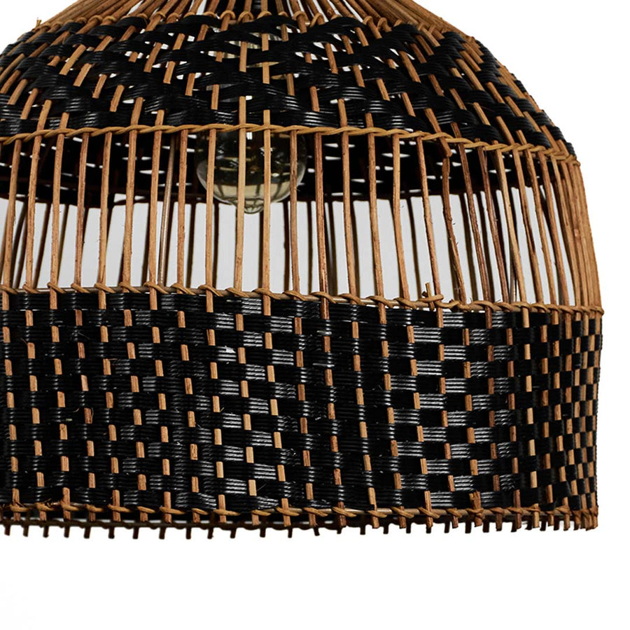 Closeup of rattan pendant light showing detailed craftsmanship with black and brown interwoven pattern.