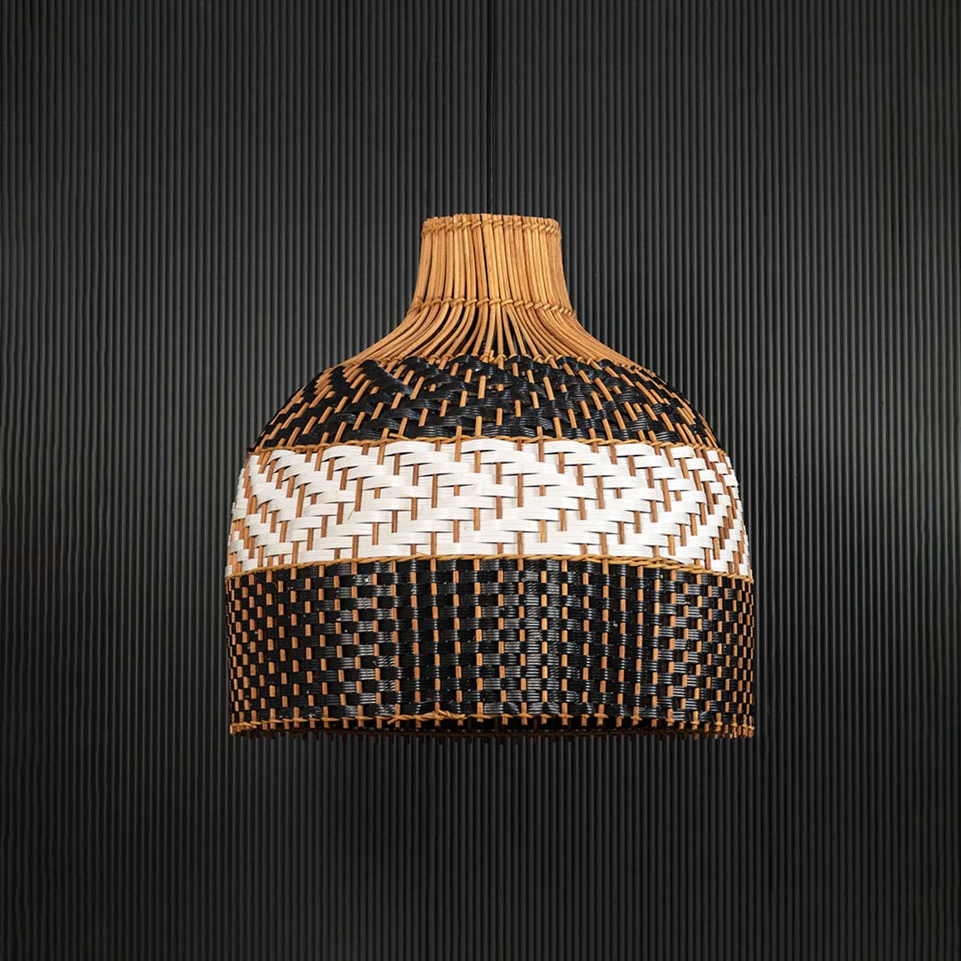 Three-tone rattan pendant light on black background showcasing intricate weaving and detailed dome silhouette.