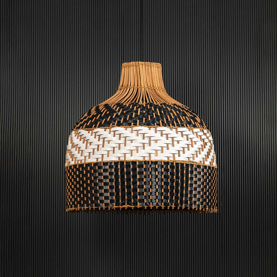 Three-tone rattan pendant light on black background showcasing intricate weaving and detailed dome silhouette.
